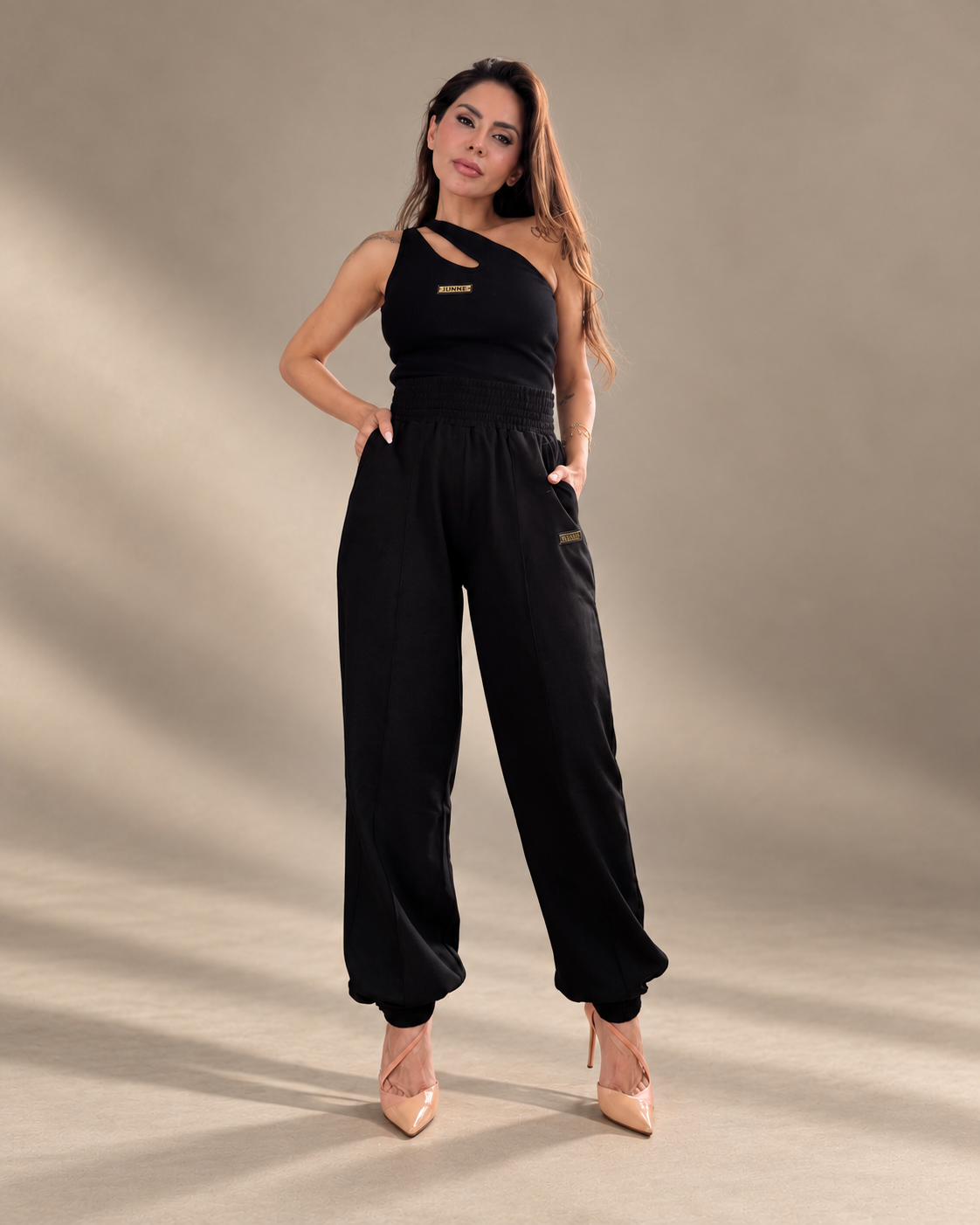 JUNNE Midnight Duo Co-ord Set — full-length front view of the black Kylie Top and Mila Joggers in a minimal taupe studio