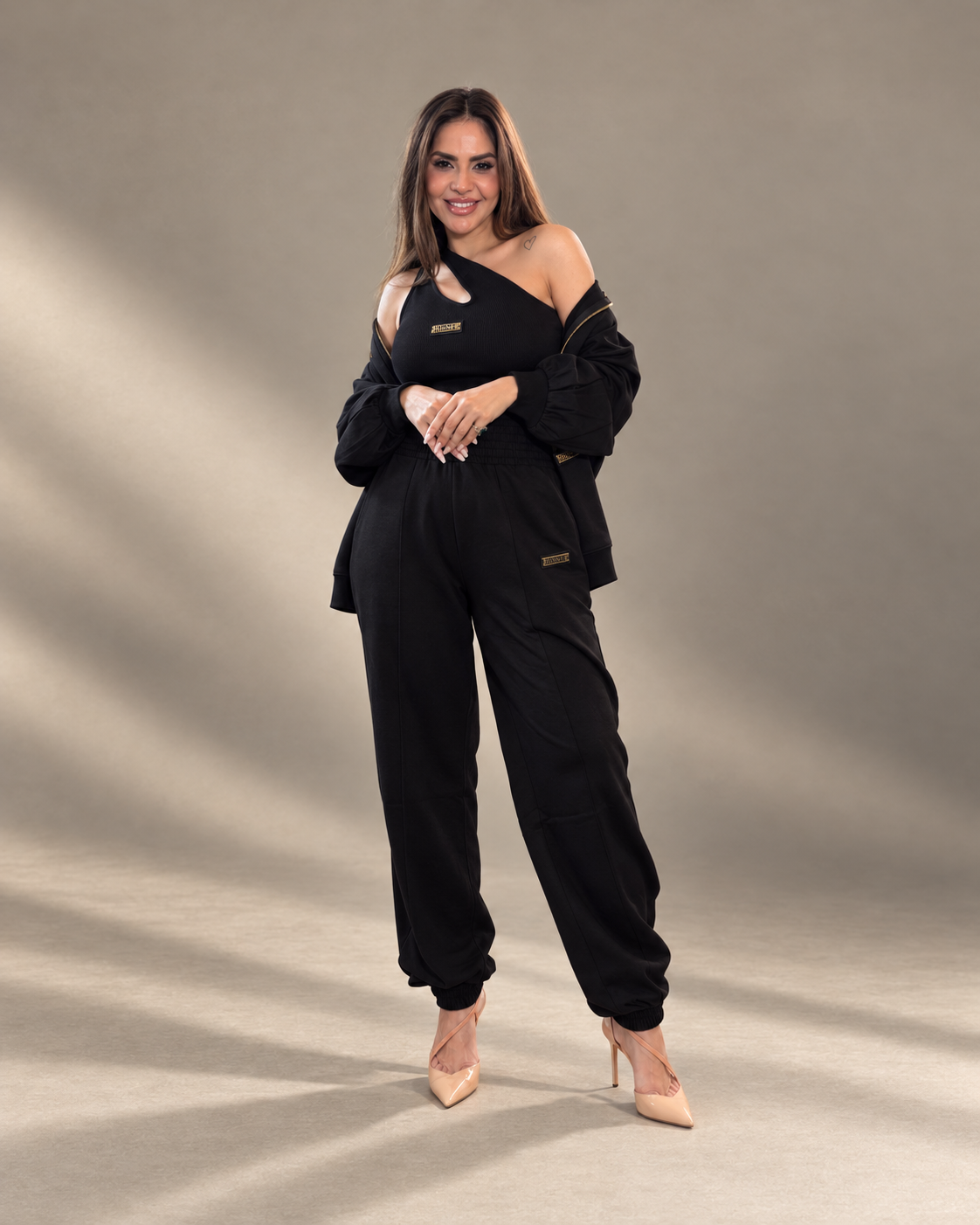 JUNNE Midnight Trio Co-ord Set — black Kylie Top, Kendall Jacket and Mila Joggers; full-length smiling standing view